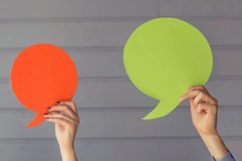 Hands with speech bubbles Stock Photos