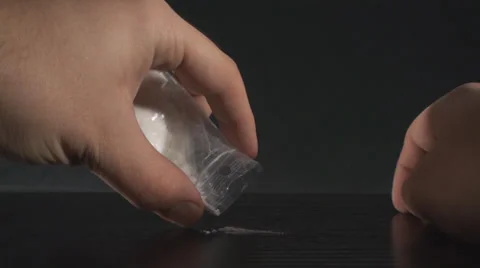 Hands Spilling Cocaine on a Black Surface Point of View-Shot Stock Footage 34975620