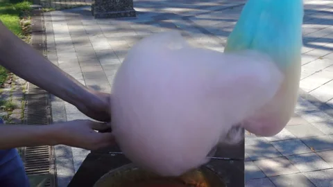 Hands spin candyfloss in slow motion Stock Footage 138575670