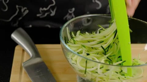 Hands Spiralizing Zucchini into Bowl During Cooking Stock-Footage 341434425