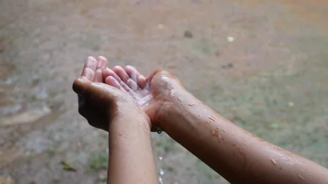 Hands with splashes of falling rain Stock Footage 301222805