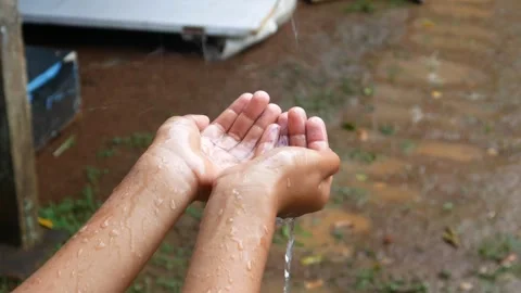 Hands with splashes of falling rain Stock Footage 301222817