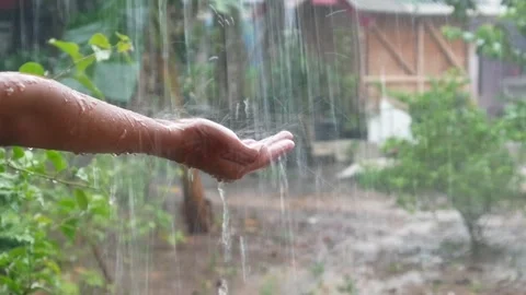Hands with splashes of falling rain Stock Footage 302384748