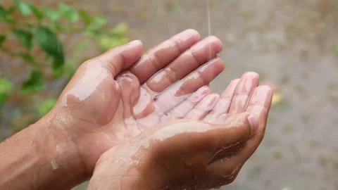 Hands with splashes of falling rain Stock Footage 302594463