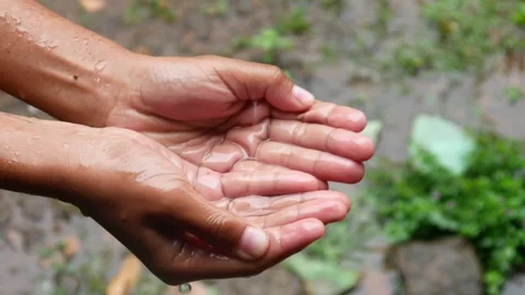 Hands with splashes of falling rain Stock Footage 302594470