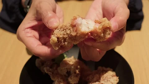 Hands split crispy fried chicken karage Stock Footage 338347988