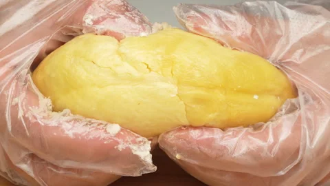 Hands Splitting Ripe Durian Pulp in Slow Motion Stock-Footage 327547735