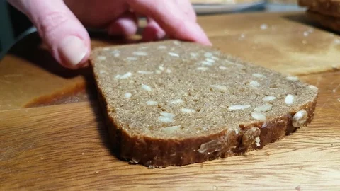 Hands spread cheese on bread Stock Footage 83957893