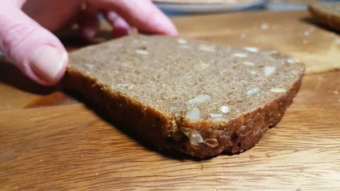 Hands spread cheese on bread Stock Footage 83957906