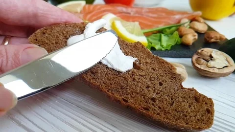 Hands spread mayonnaise on bread butter Stock Footage 87126336