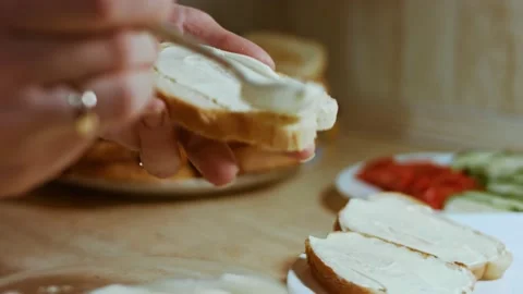 Hands spread mayonnaise on bread butter. holiday food Stock Footage 144446461