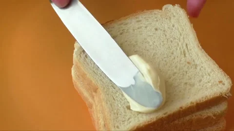 Hands spread mayonnaise on the sandwich 库存影片 63296612