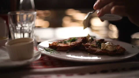 Hands spread the sauce on the meat chops on a plate Close-up Stock Footage 150276545
