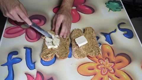 Hands Spreading Butter On Brown Bread Top Down Stock Footage 343889776