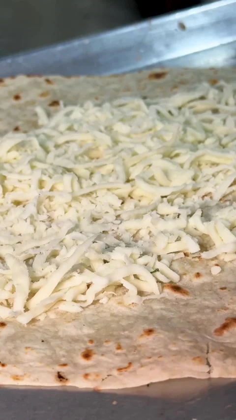 Hands Spreading Cheese on Tortilla Stock Footage 318749359