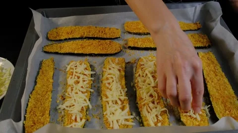 Hands Sprinkling Cheese on Baking Sheet in Cooking Kitchen Video stock 341452668