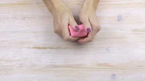 Hands squeeze plasticine, relieving stress Video stock 99506750