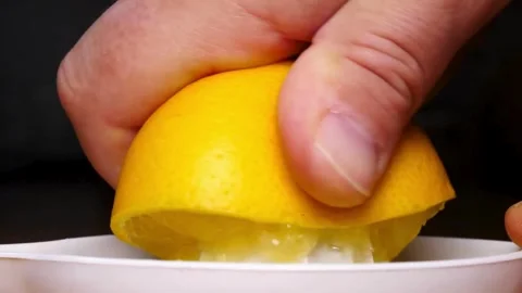 Hands Squeezing Fresh Organic Lemons. Lemon is pressed on with hand juicer. Stock Footage 265839617