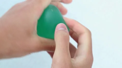 Hands squeezing green slime toy stress ball Stock Footage 318070214
