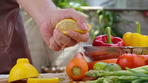 Hands squeezing lemon juice Vegan Lettuce Salad Dressing. Healthy food and .. Stock Footage 265839708