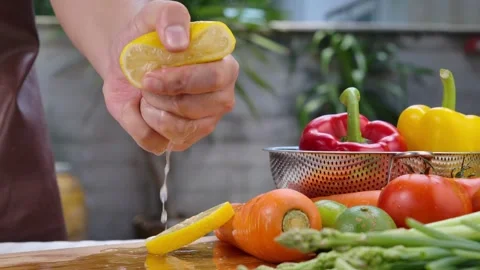 Hands squeezing lemon juice Vegan Lettuce Salad Dressing. Healthy food and Stock-Footage 336588727