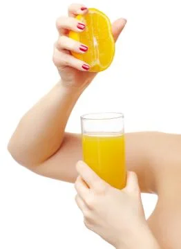 Hands squeezing out orange Stock Photos
