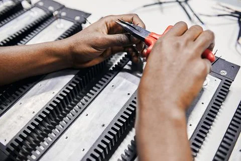 Hands squeezing wire with tongs Stock Photos