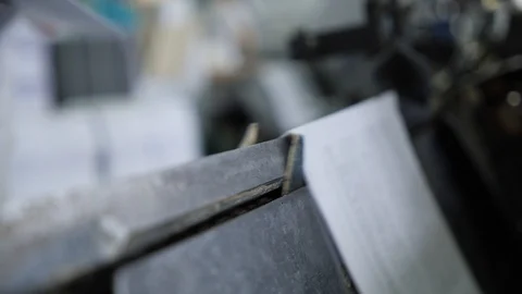 Hands stack the pages of the future book on the conveyor in the printing house. Stock Footage 98120091