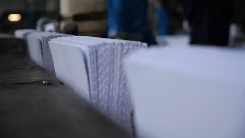 Hands stack the paper pages of the future book on the conveyor in the typography 스톡 동영상 98119528