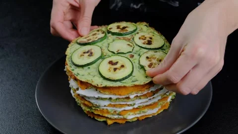 Hands Stacking Pancakes with Cream and Zucchini in Cooking Scene Stock Footage 341443585