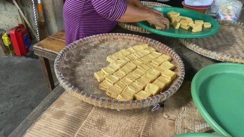 Hands stacking tofu on a tray at Traditional tofu factory Stock Footage 309373689