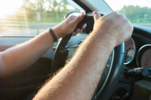 Hands on the steering wheel  of the car driver Stock Photos