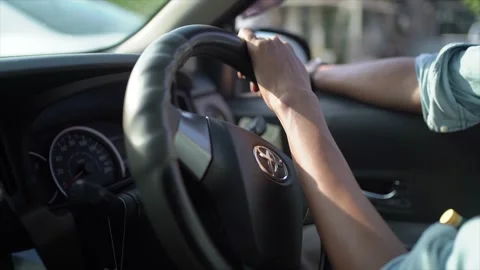 Hands on the steering wheel in car. People driving car on day time. Take Stock Footage 248492647