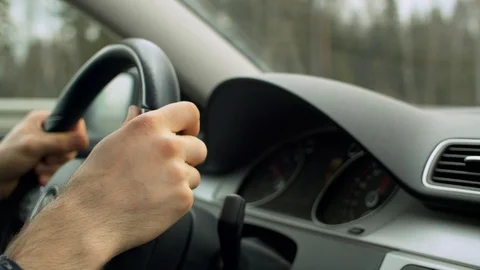 Hands on the steering wheel of a car. POV Stock Footage 128790089