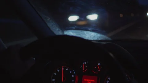 Hands on steering wheel, dashboard, car driving, night road Stock Footage 103098323
