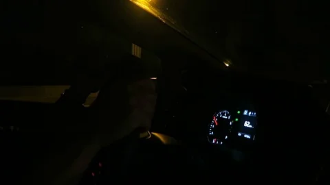 Hands on steering wheel driving on freeway at night. Stockbeeldmateriaal 97430000