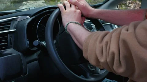 Hands on Steering Wheel with Flashing Red and Blue Police Lights in Background Stock Footage 332091067