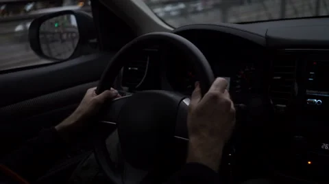 Hands on a steering wheel: man driving a car in the city Stock Footage 67673967