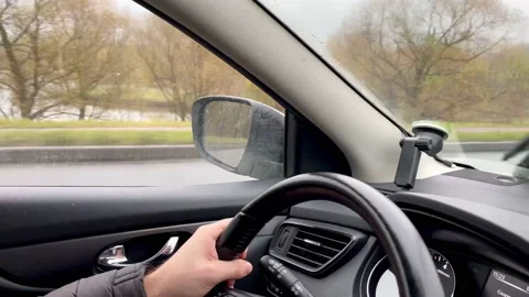Hands on the steering wheel, a man driving a car on the road Stock Footage 220865371