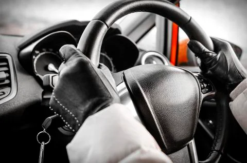 Hands on a steering wheel Stock Photos