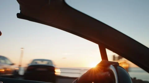 Hands on the steering wheel at sunset Stock Footage 116178839