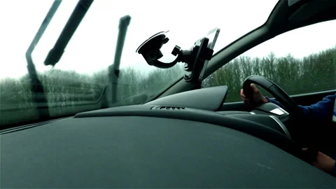 Hands on steering wheel while driving in the rain Stock Footage 132132395