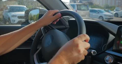 Hands on Steering Wheel While Driving in City 库存照片