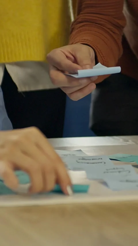 Hands stick blue sticky notes on a white board Video stock 331772859