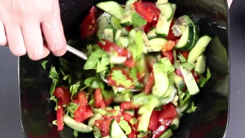 Hands stir vegetable salad close-up. Top view Stock Footage 132726659