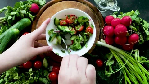 Hands stir the vegetable salad with a spoon Stock Footage 153765264