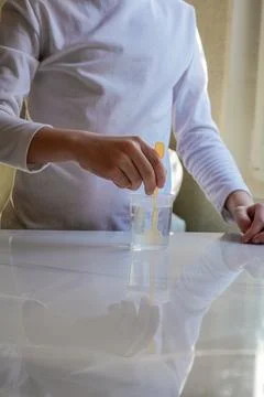 Hands Stirring Liquid in Measuring Cup Vertical Stock Photos