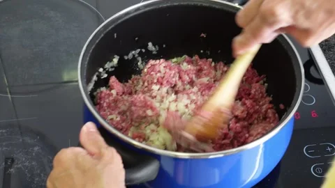 Hands stirs ground beef and chopped onions Stock Footage 283865704