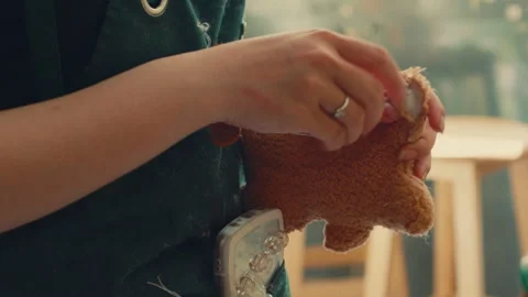 Hands Stitching a DIY Bear at Build-A-Bear Workshop - Close Up Stock Footage 296278285