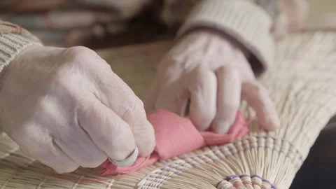 Hands Stitching Fabric on Straw for Bon Odori Hat Craft in Ugo Town, Akita, Japa Stock Footage 340319735